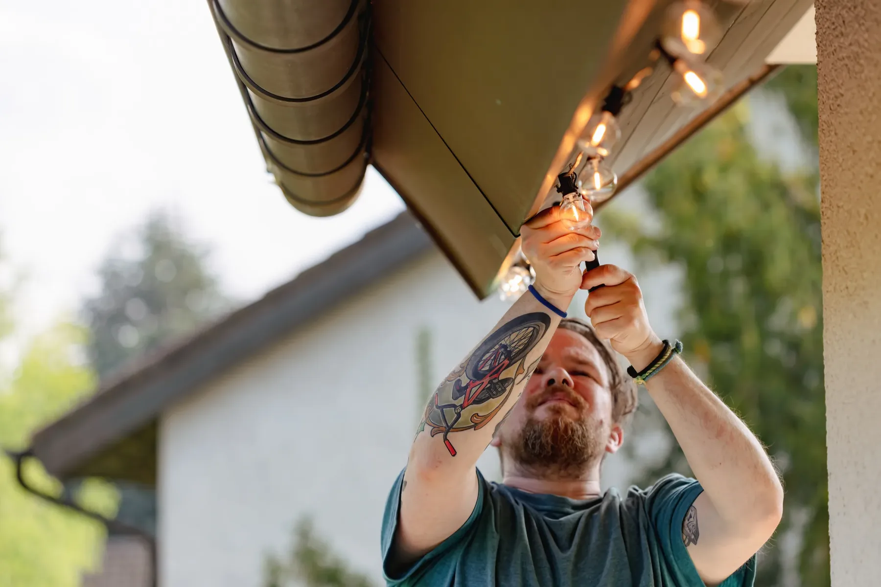 Installer hanging outdoor string lights.