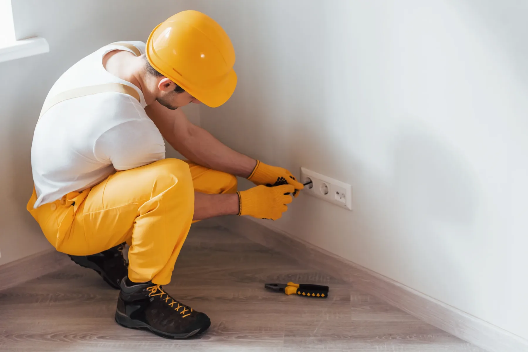 Technician working on a household electrical outlet.