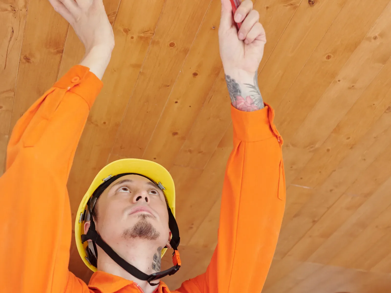 Smoke detector installation on an indoor ceiling.